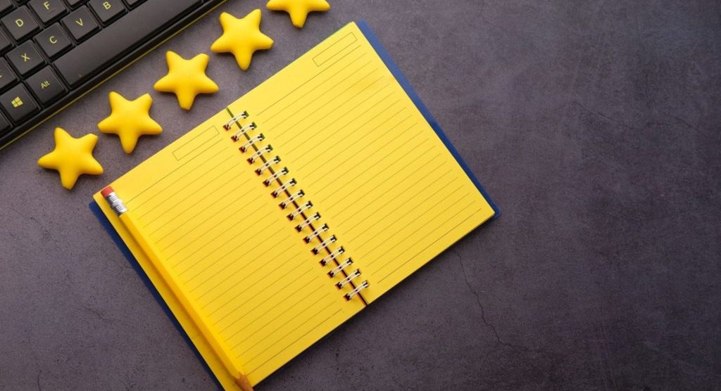 yellow notebook with review stars