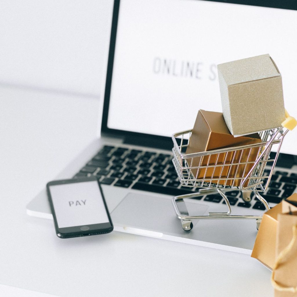 computer with small shopping cart full of boxes
